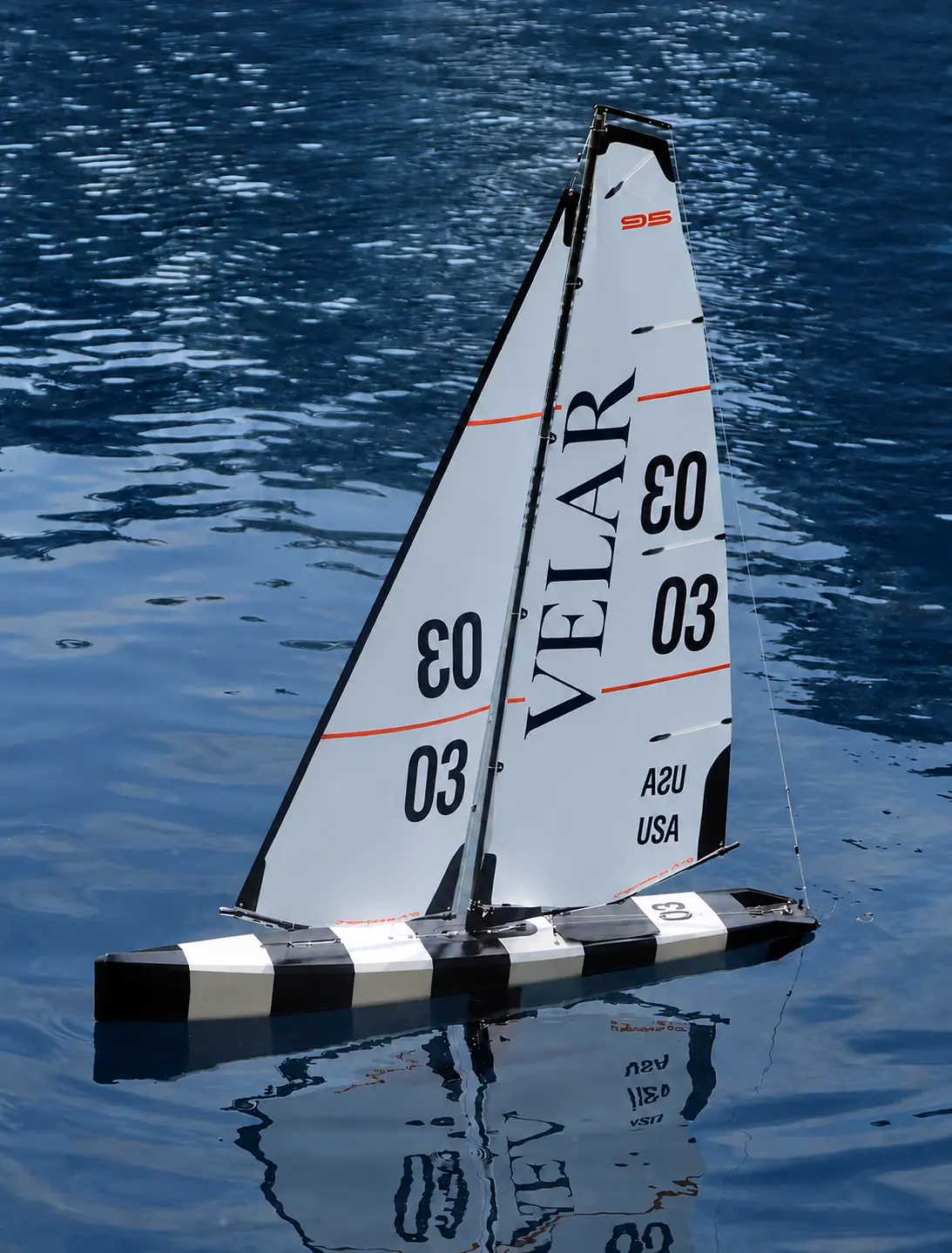 Racing sailboat with VELAR 03 sails over deep blue water